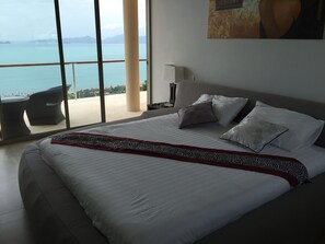 A hotel room with a large bed, a view of the sea, and a balcony with outdoor furniture. - 16 Bedroom Sea View Triple Villas Angthong Hills SDV205/SDV227/SDV190-By Samui Dream Villas (Koh Samui)