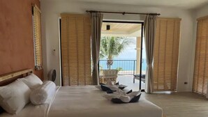 A hotel room with a large bed, wooden headboard, and a balcony with wooden shutters. - 16 Bedroom Sea View Triple Villas Angthong Hills SDV205/SDV227/SDV190-By Samui Dream Villas (Koh Samui)