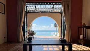 A room with a view of the sea through an arched doorway. - 16 Bedroom Sea View Triple Villas Angthong Hills SDV205/SDV227/SDV190-By Samui Dream Villas (Koh Samui)