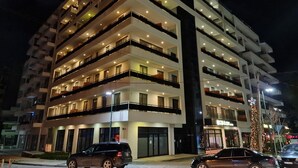 A multi-story hotel with balconies, a ground-level entrance, and a Christmas tree decoration. - Regina City Hotel (Vlorë)