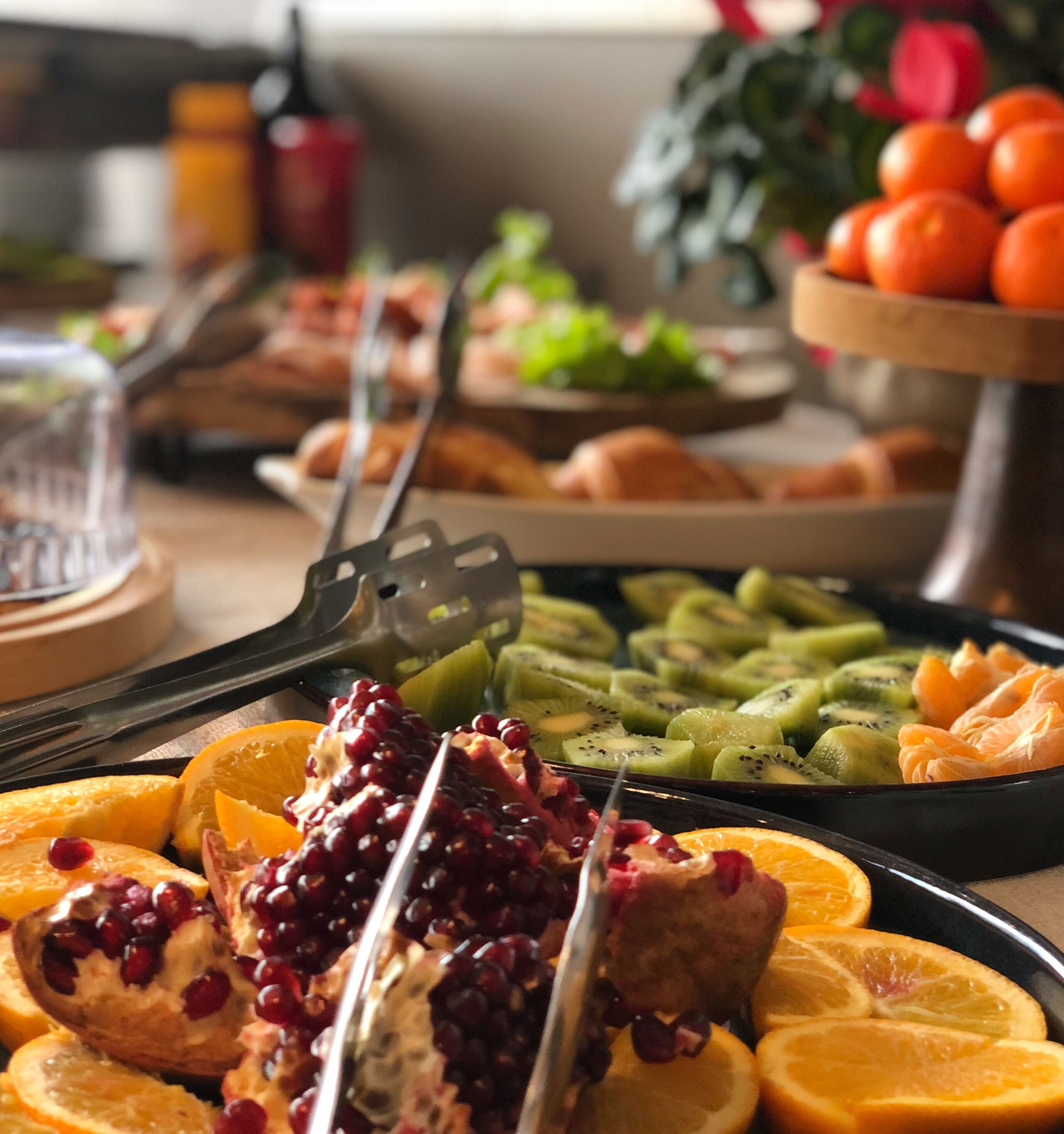 A buffet with various fruits and pastries.