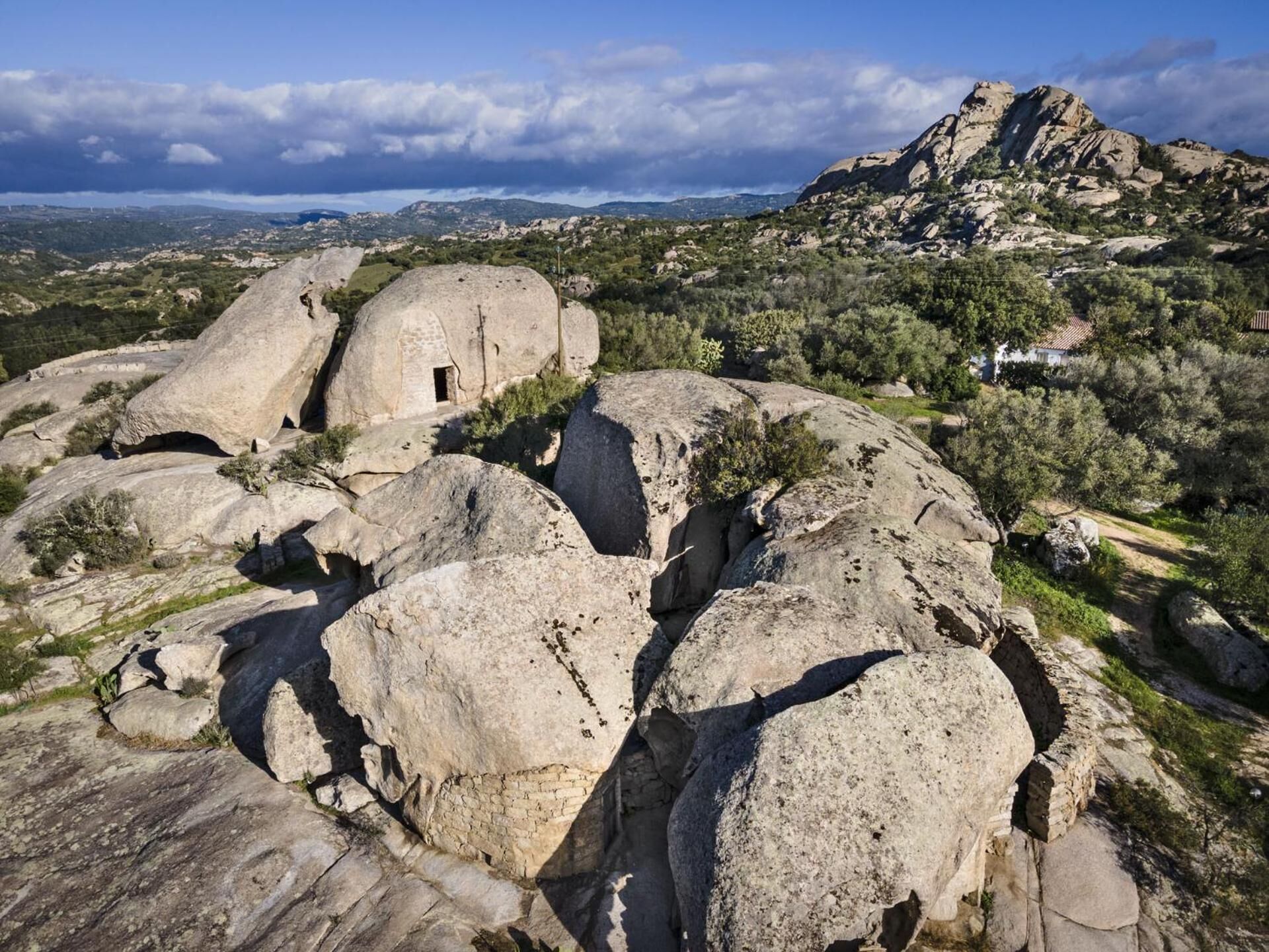 A large rock formation with a small cave-like structure.