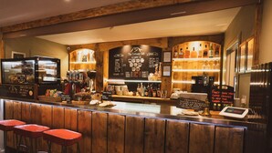A bar area with wooden accents, a menu board, and a coffee machine. - SeaBeds Luxury Lookouts with Hot Tubs (Ballachulish)