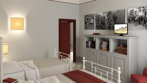 A bedroom with a bed, bedside table, lamp, and a television on a stand. - Brolio Agriroom (Gaiole in Chianti)