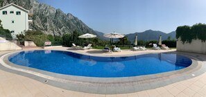 Seasonal outdoor pool, open 9:00 AM to 9:00 PM, pool umbrellas