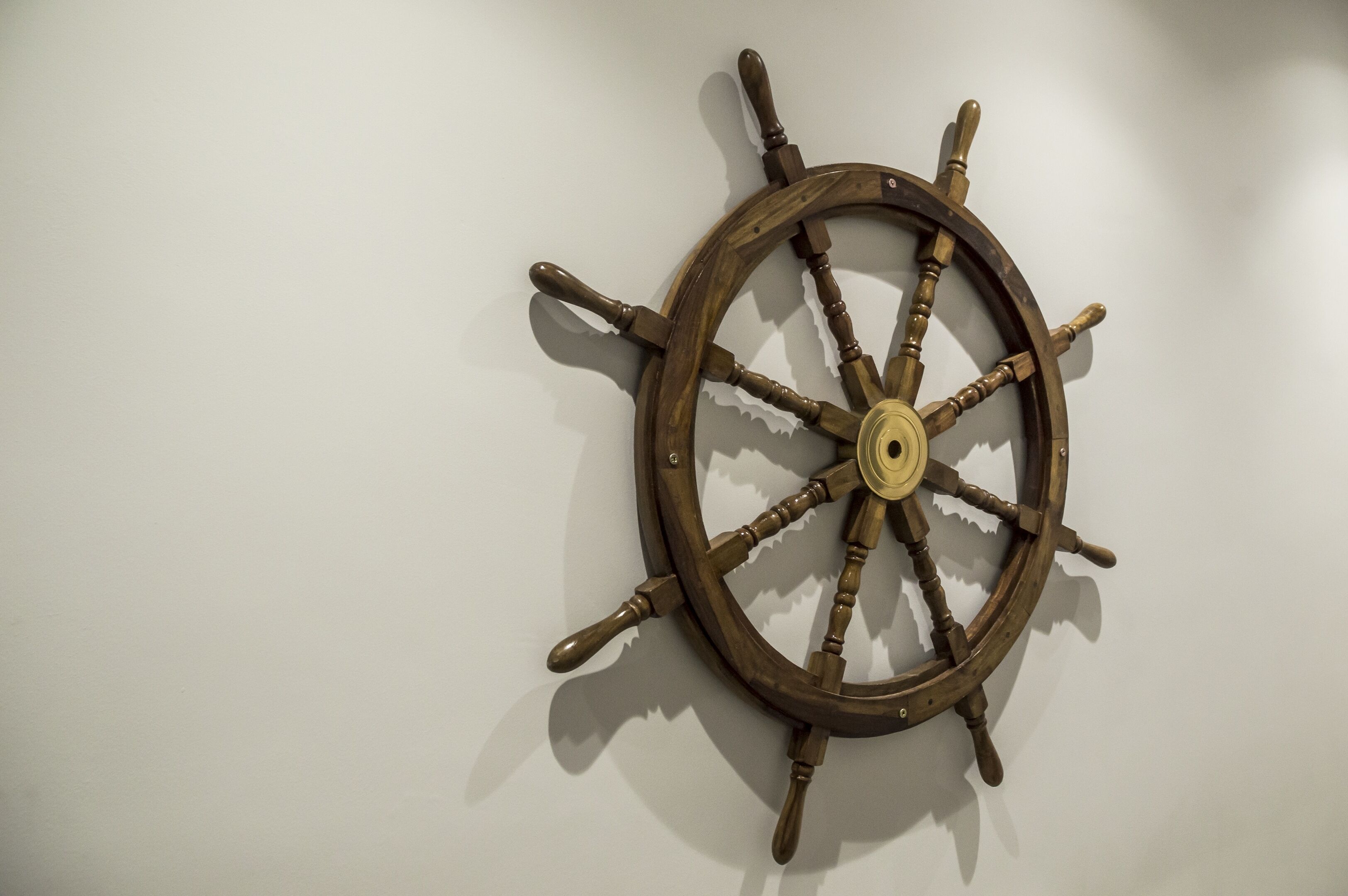 A wall-mounted wooden ship's wheel.