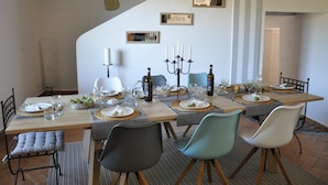 A dining area with a long table set for six, featuring a candelabra centerpiece, plates, glasses, and a bottle of wine. - "Paradise Found" Stunning Rural Setting - Pure Peace and Quiet 100% Guaranteed! (Ordan-Larroque)