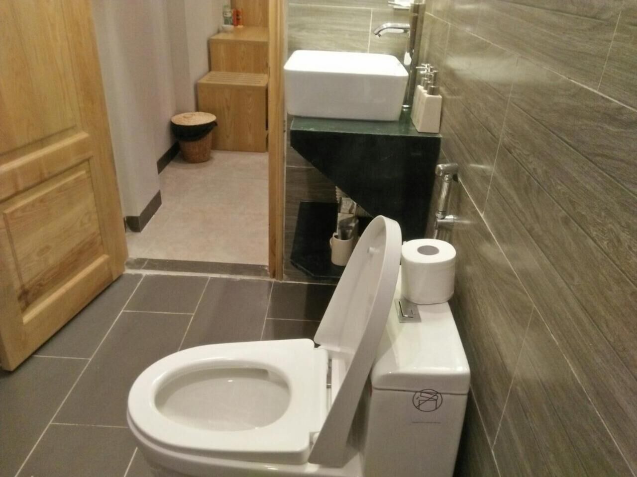 A modern bathroom with a toilet, a sink, and a shower area.