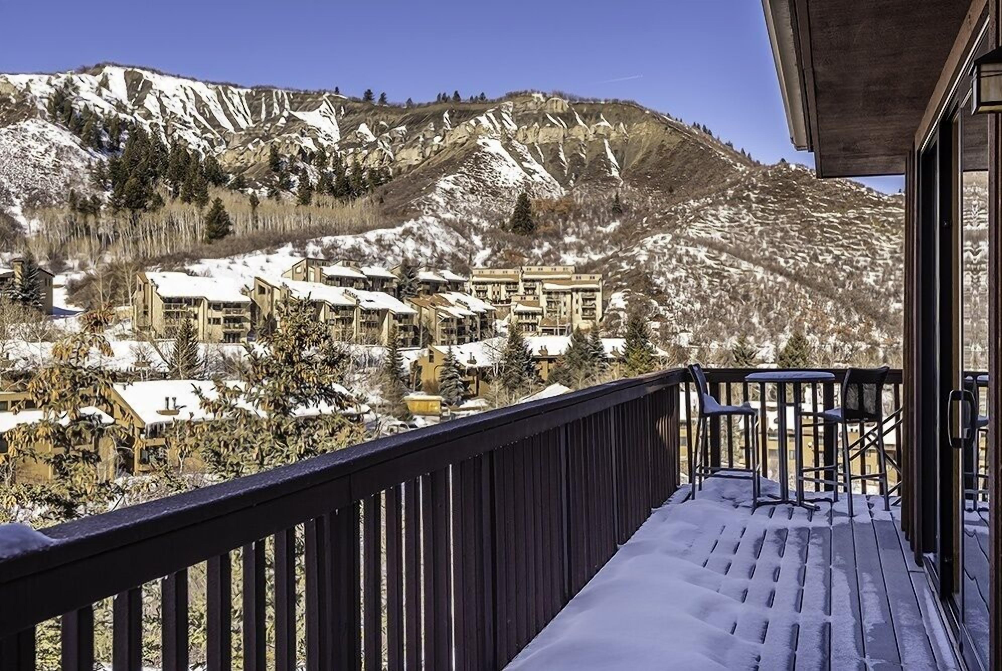 A snow-covered mountain landscape with buildings in the background.