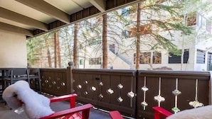 A balcony with red chairs and a wooden railing. - Villa Cortina Condo with 5 Minutes Walk to Gondola by RedAwning (Vail)