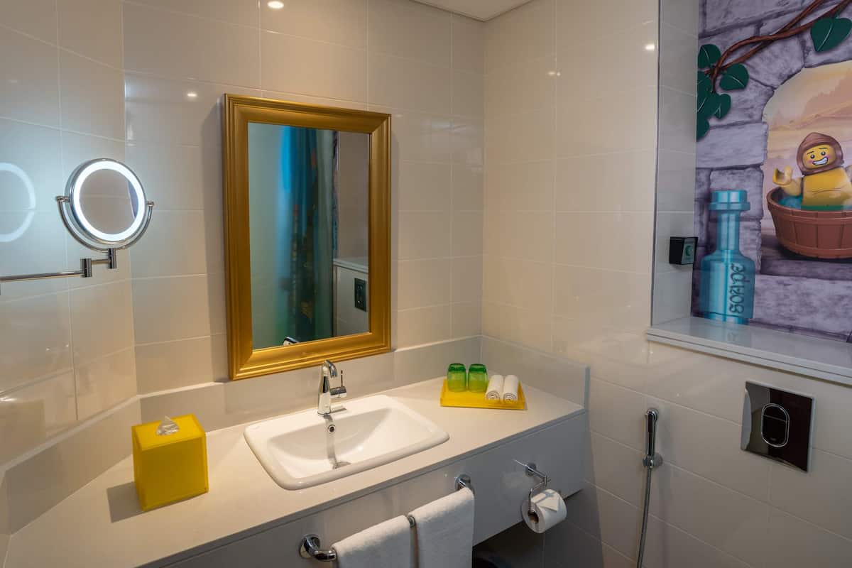 kingdom fully themed room with park access | bathroom | free toiletries, hair dryer, slippers, towels