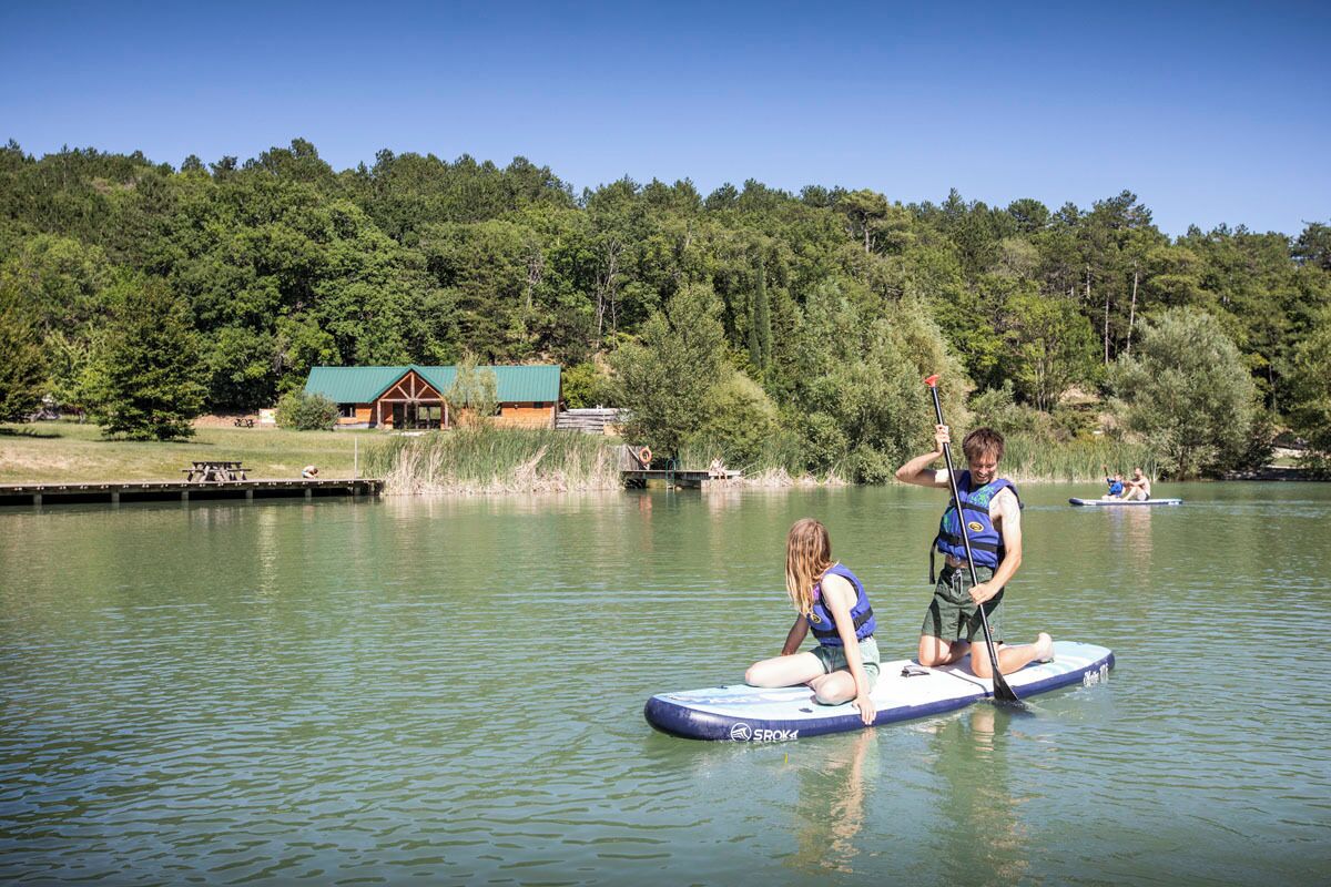 A lakeside scene with a cabin and a dock.