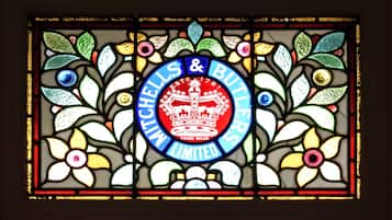 A stained glass window with the text "Shells & Butlers Limited" and a crown emblem.