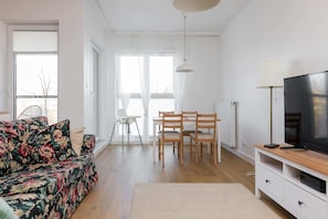 Comfort Apartment | Living room | 30-inch flat-screen TV with satellite channels, TV