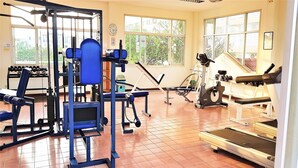 A gym with various exercise equipment, including a treadmill, elliptical, and weight machines. - 13th Floor sea View Studio (Pattaya)