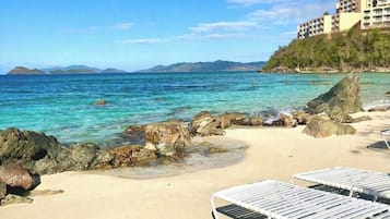 On the beach, sun-loungers, beach towels