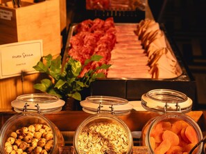 A buffet with various food items including dried fruit, nuts, and granola. - Mercure Roma Cinecittà  (Rome)