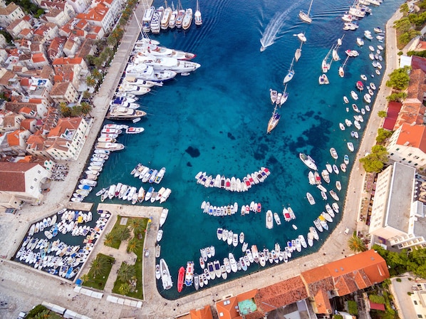 Boats docked in a circular pattern at the marina, surrounded by traditional waterfront architecture.