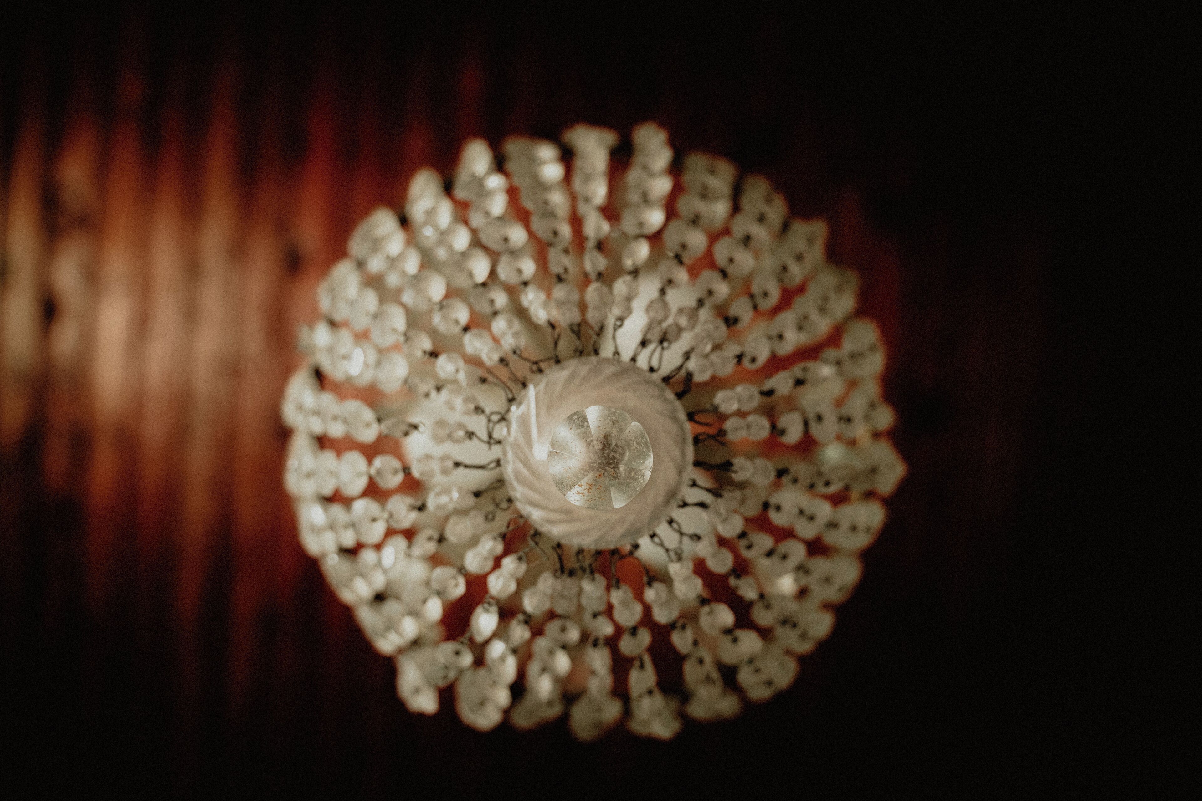 A chandelier with multiple light bulbs arranged in a circular pattern.