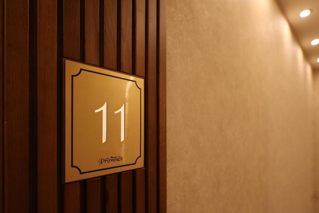 A hotel room number sign with the number 11 and the word "Provence" indicating the location.