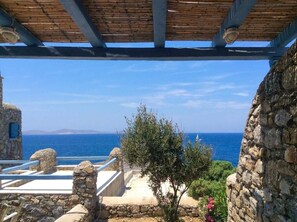 A stone structure with a view of the sea.