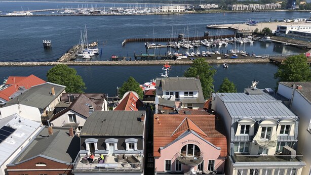 A marina with boats docked, a building with a balcony, and a sign reading "Villa Brunhilde". - 80 m from the beach, everything in view - Anchorage vacation apartment (Rostock-Warnemünde)
