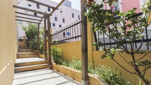 A staircase leading to a building with a metal fence and greenery. - Relaxing Guesthouse - Sónia's Houses (Lisbon)