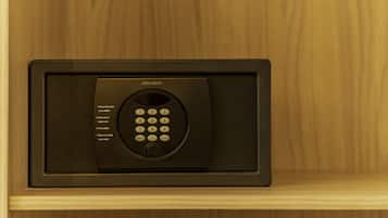 A black electronic keypad with instructions for use, mounted on a wooden surface.