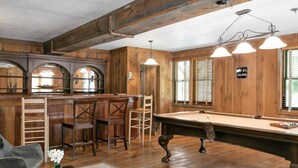 A cozy bar area with wooden furniture, a pool table, and a bar counter. - Lyric Retreat at GratiDude Ranch - Sleeps 23 with Pool in Leiper's Fork (Franklin)