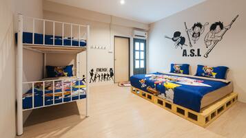 A room with bunk beds, a bed with a cartoon-themed bedspread, and a wall with anime characters.