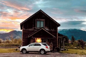 Escape to a serene mountain retreat with a cozy cabin nestled among the peaks.