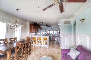 Enjoy meals at the central island with bar stools and dine at the nearby table.