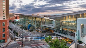 A modern building with large glass windows and a blue sculpture in front. - Meadowlark Apartment - 10 min to Denver, 1 hr to Mnts/skiing (Lakewood)