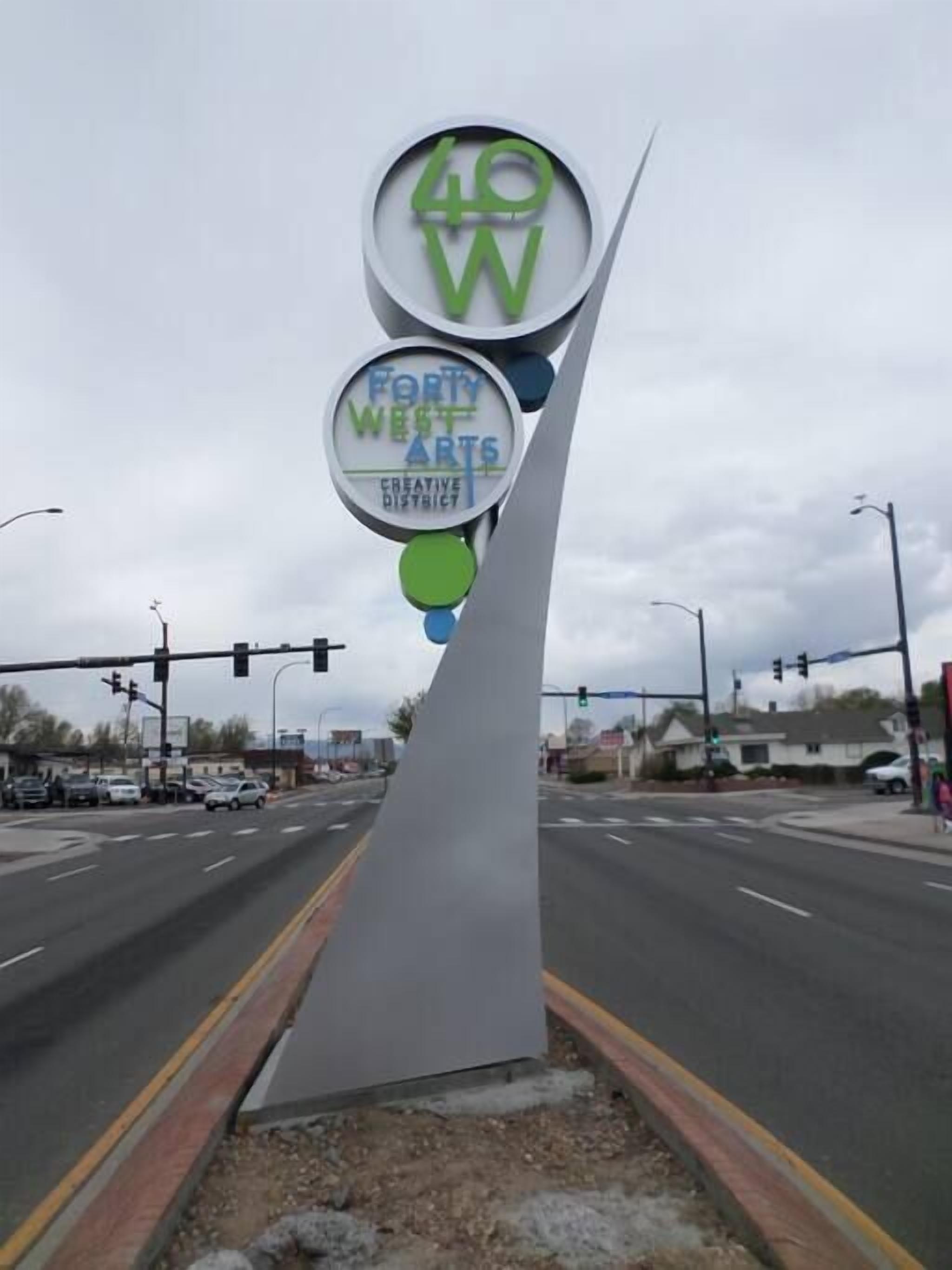 A traffic sign with "Forty West Arts Creative District" text.