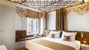 A bedroom with a large bed, a window with curtains, a bench, and a decorative ceiling. - Gallery 37 (Plovdiv)
