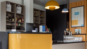 A reception area with a counter, shelves with beverages, and a menu board.