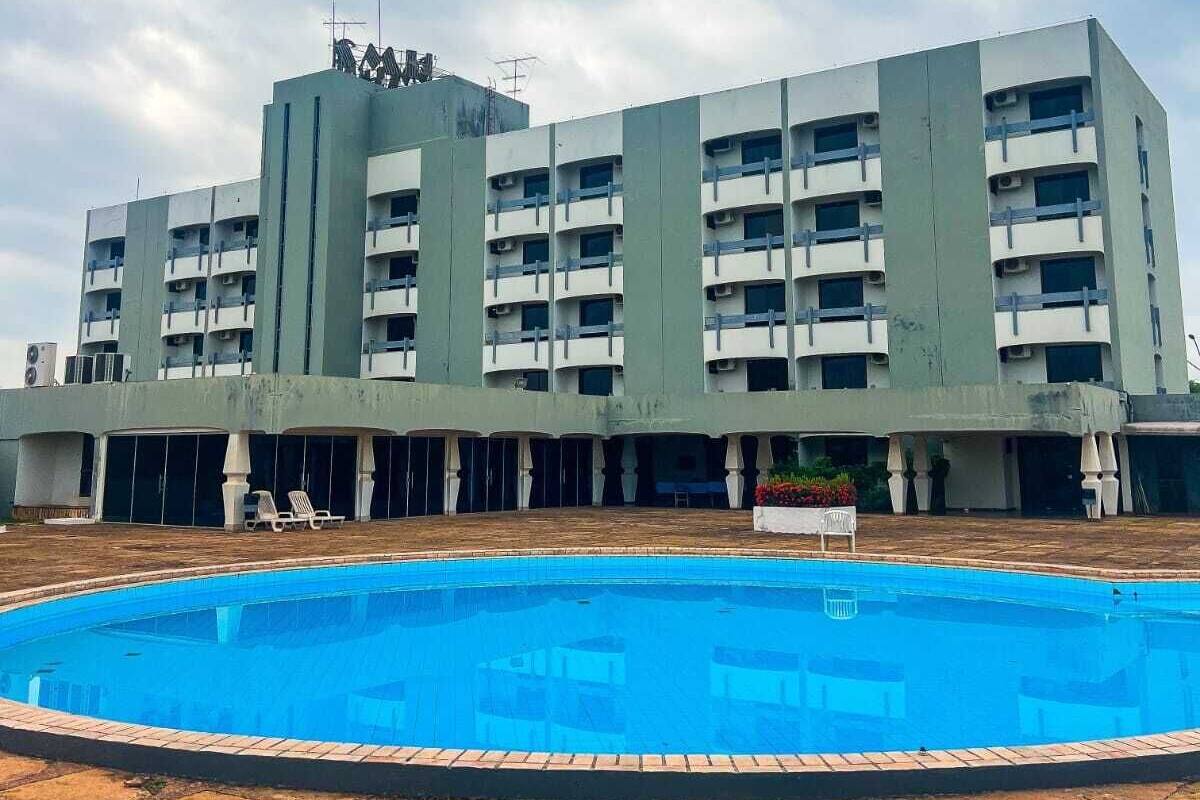 A multi-story building with a swimming pool in the foreground.