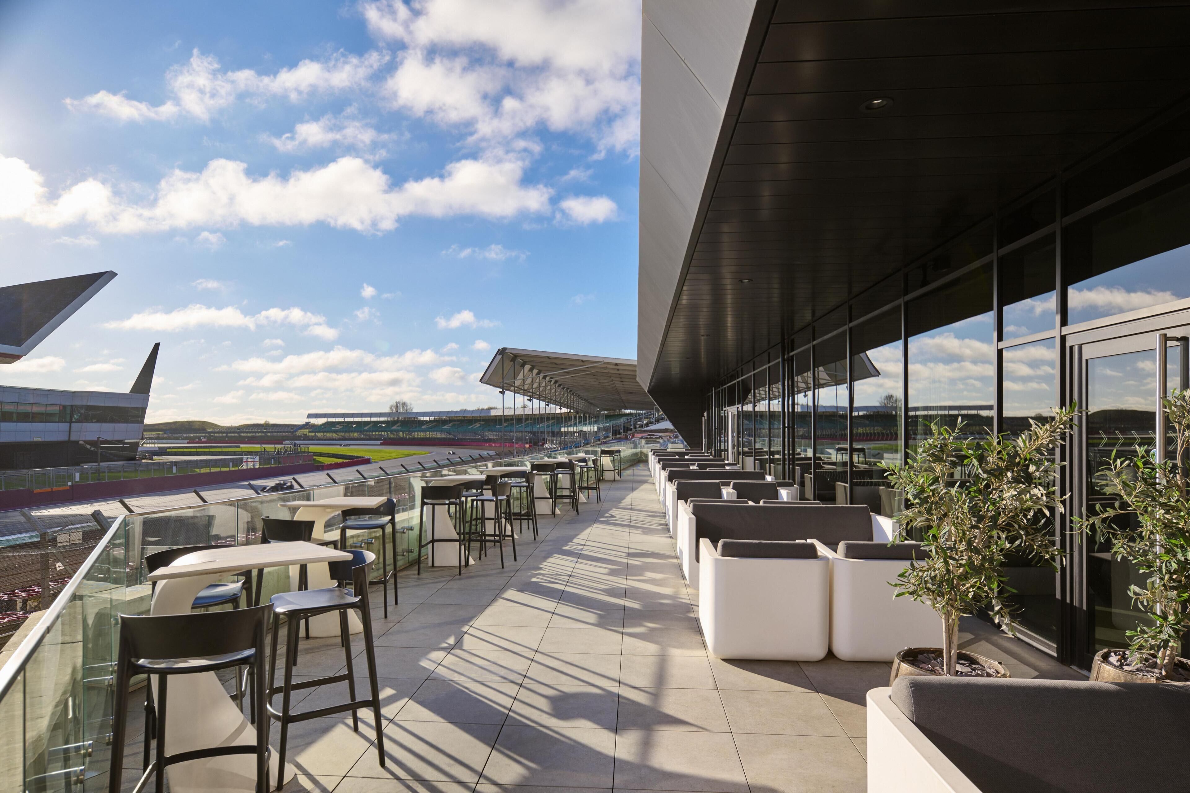 An outdoor terrace with seating and a view of the sky.
