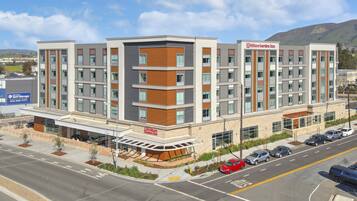 A multi-story hotel with a modern design, featuring a prominent Hilton Garden Inn sign.