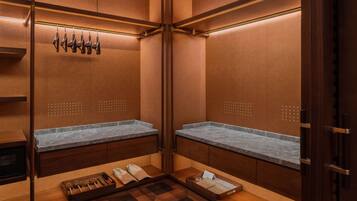 A modern bathroom with wooden cabinetry, marble countertops, and a wooden floor.
