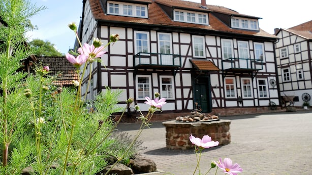 A traditional half-timbered building with a stone bench in front.