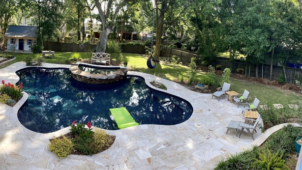 A backyard with a swimming pool, outdoor seating, and a small house. - The Perfect Relaxing Oasis for your family’s Island Getaway (Isle of Palms)