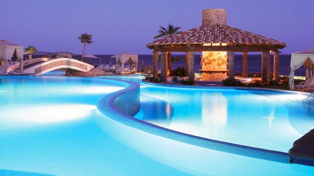 A swimming pool with a gazebo, palm trees, and a bridge. - Pueblo Bonito Sunset Resort, Cabo San Lucas, Mexico (Cabo San Lucas)