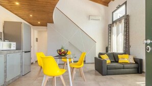 A modern kitchen with a dining area, a sofa, and a window with curtains. - Detached villa with outdoor hot tub, swimming pool and lawn  (La Spezia)