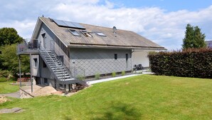 A two-story house with a balcony, a staircase, and solar panels on the roof. - Apartment in Weywertz Near Ski Slopes (Buetgenbach)