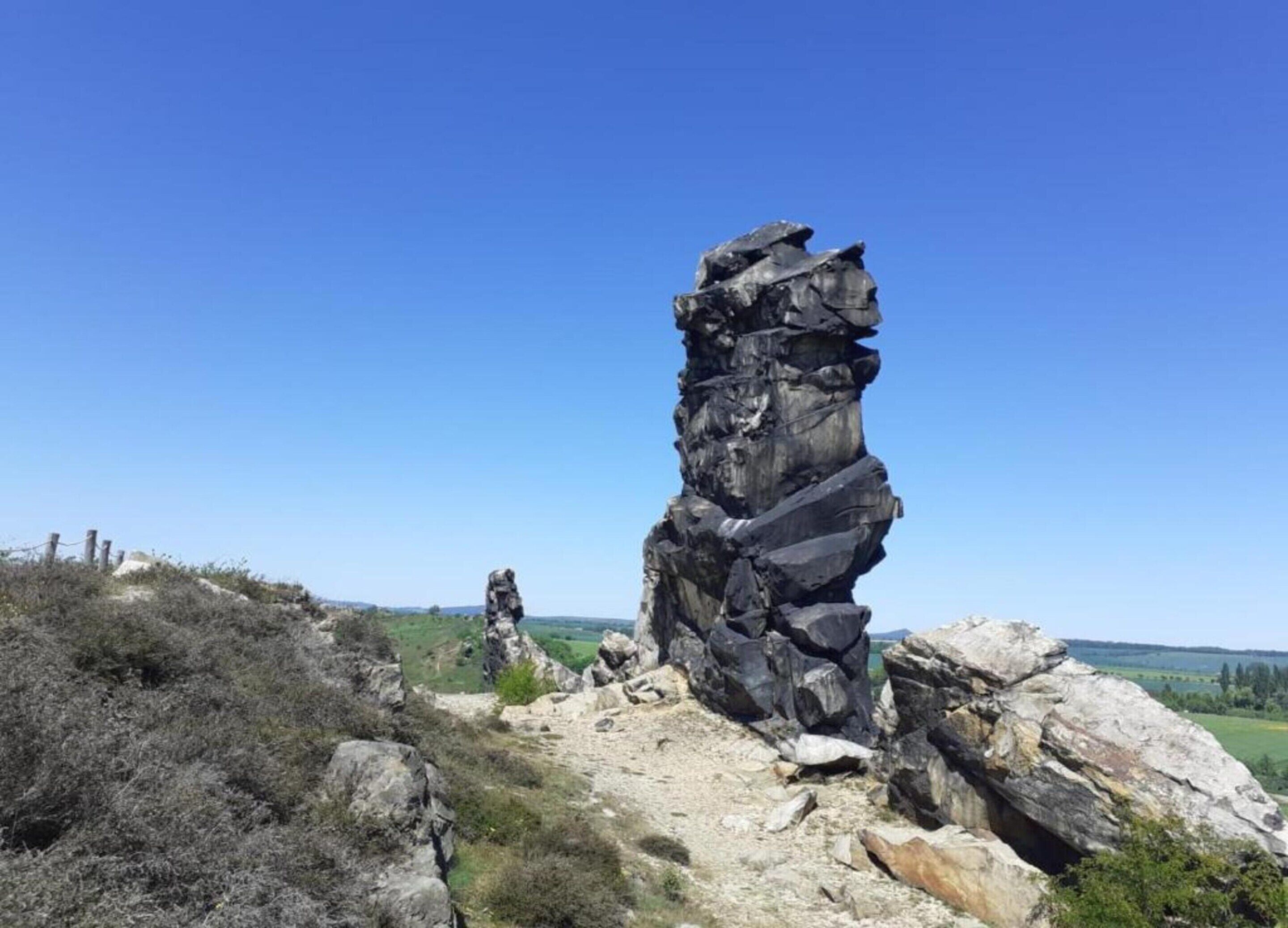 A natural rock formation with a clear sky.