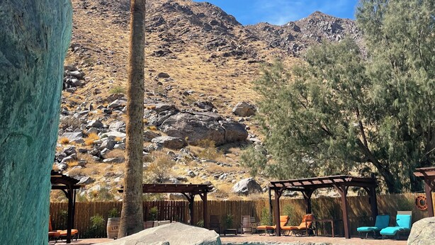 A pool area with clear blue water, surrounded by rocks and a mountain backdrop. - LAZY C RANCH - POOL, ANIMALS, DESERT RANCH EXPERIENCE (Palm Springs)