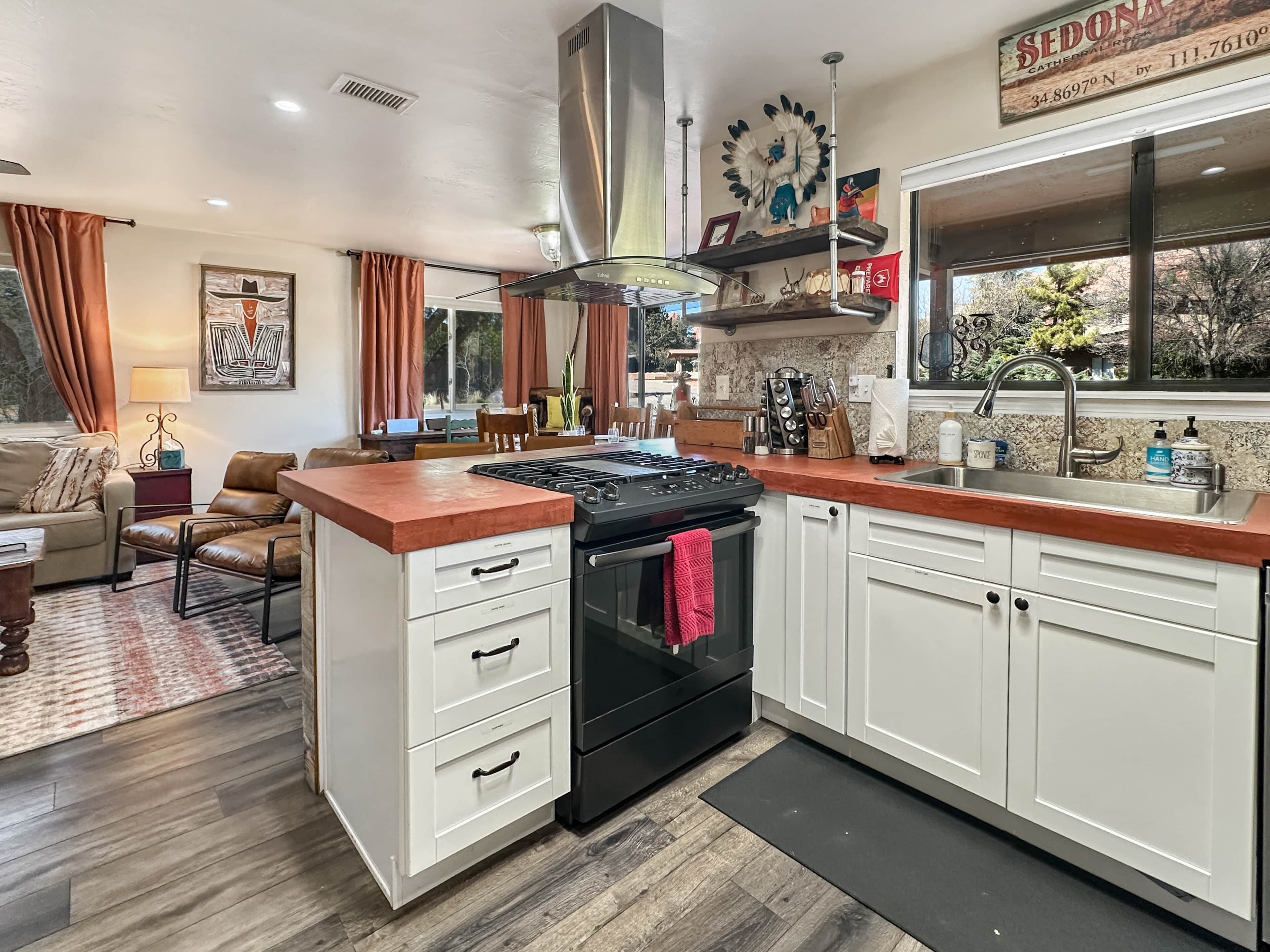 A kitchen with a stove, oven, and modern cabinetry.