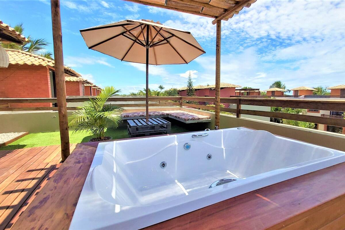 A hot tub on a wooden deck with a pergola overhead.