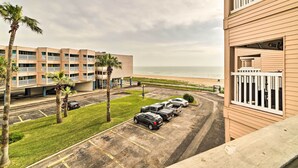 A multi-story hotel with a parking lot and a view of the beach. - Seaside Corpus Christi Condo at The Villa del Sol! (Corpus Christi)